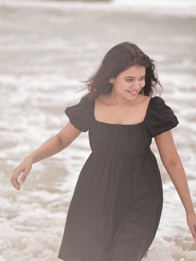 Seaside setting contrasts beautifully with Arul Jyothi's elegant black outfit choice