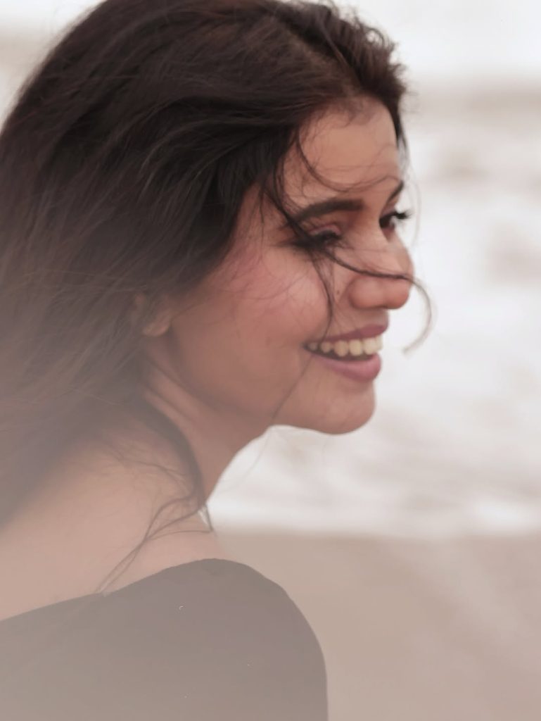 Seaside setting contrasts beautifully with Arul Jyothi's elegant black outfit choice