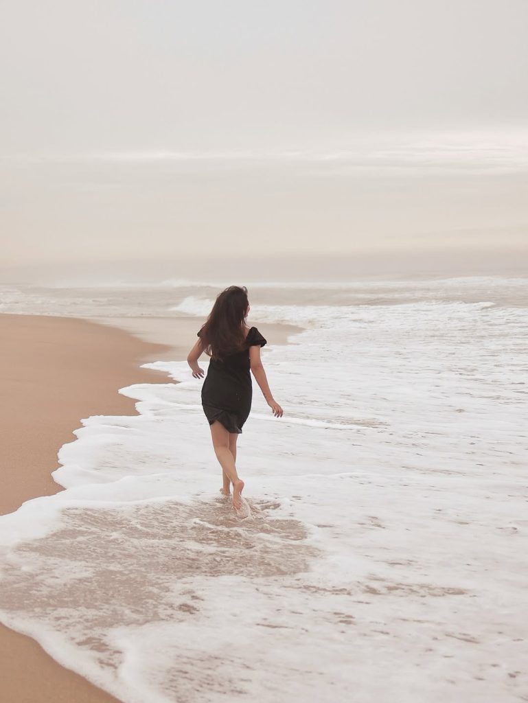 Seaside setting contrasts beautifully with Arul Jyothi's elegant black outfit choice