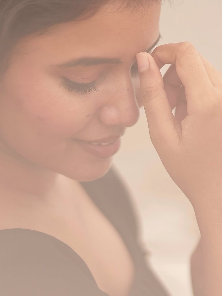 Ocean waves provide natural backdrop for Arul Jyothi's black dress beach styling