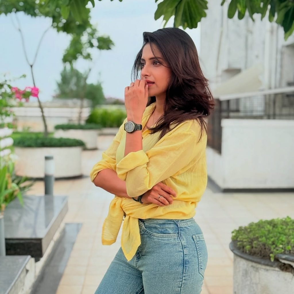 Classic blue jeans paired perfectly with Aysha's sunny yellow top