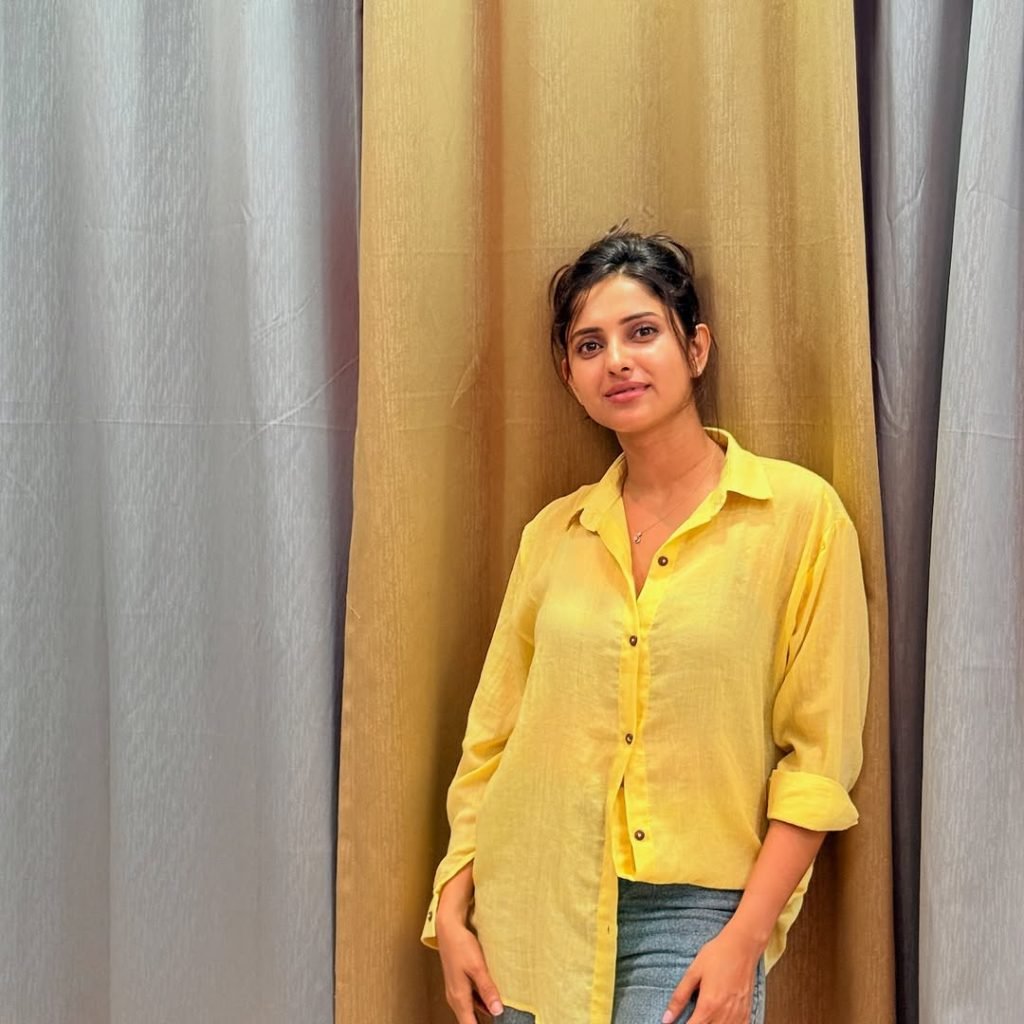 Classic blue jeans paired perfectly with Aysha's sunny yellow top