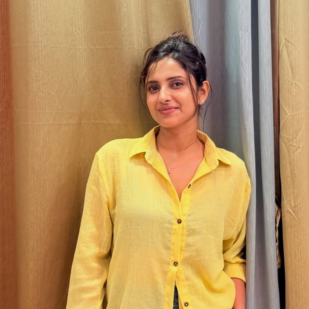 Classic blue jeans paired perfectly with Aysha's sunny yellow top