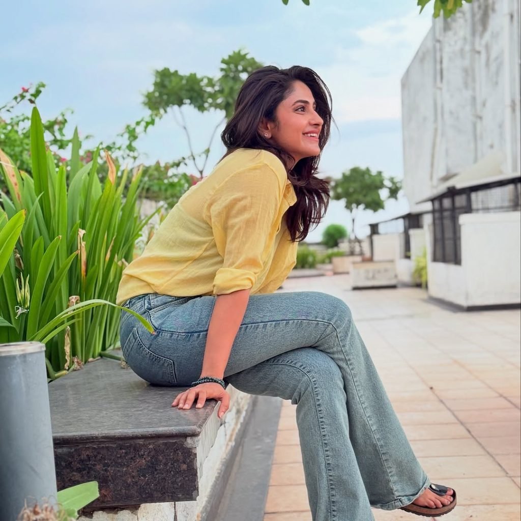 Classic blue jeans paired perfectly with Aysha's sunny yellow top