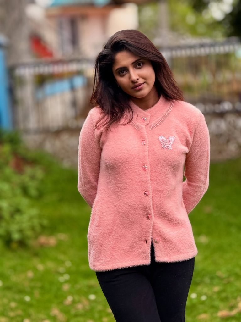 Blooming flowers frame Aysha's radiant beauty in garden setting