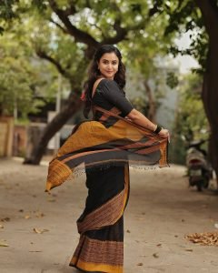 Janani Ashok Kumar embodies contrast elegance in black saree with bright yellow accent