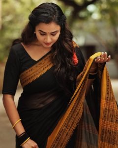Janani Ashok Kumar embodies contrast elegance in black saree with bright yellow accent