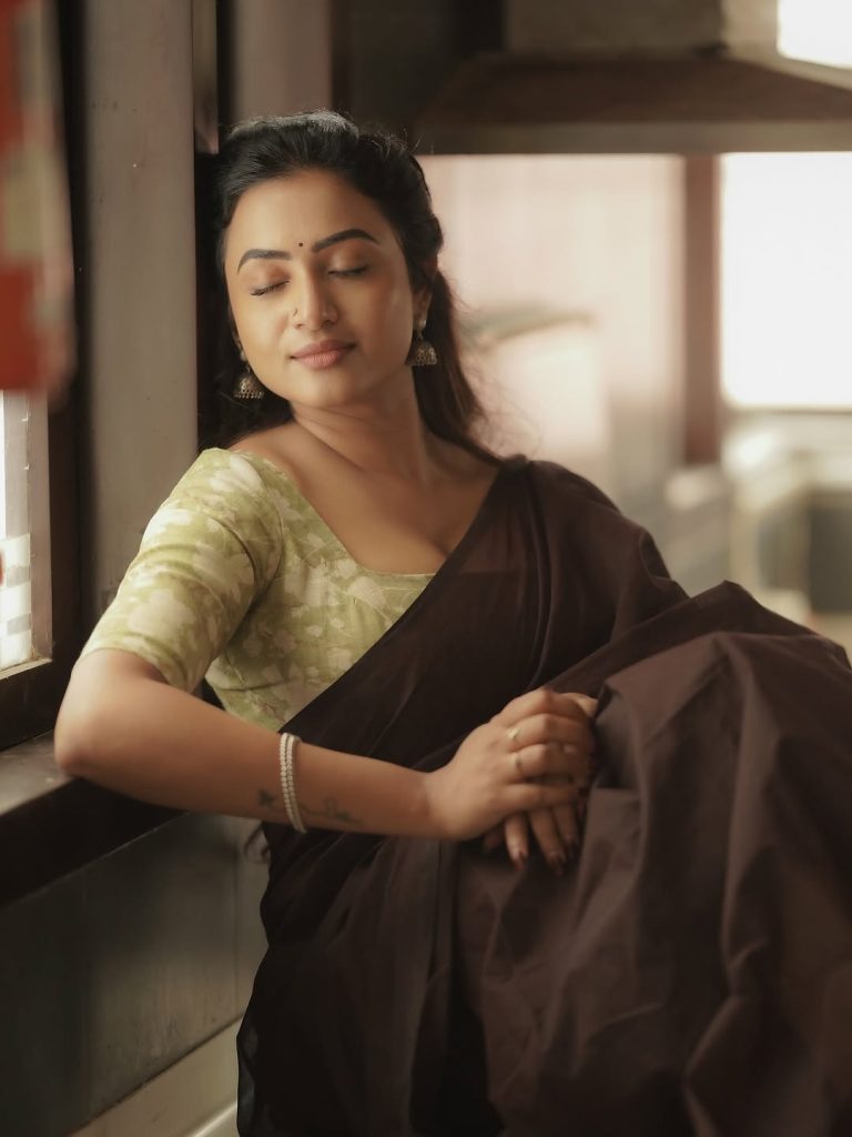 Olive green printed blouse adds perfect accent to Janani Ashok Kumar's brown saree