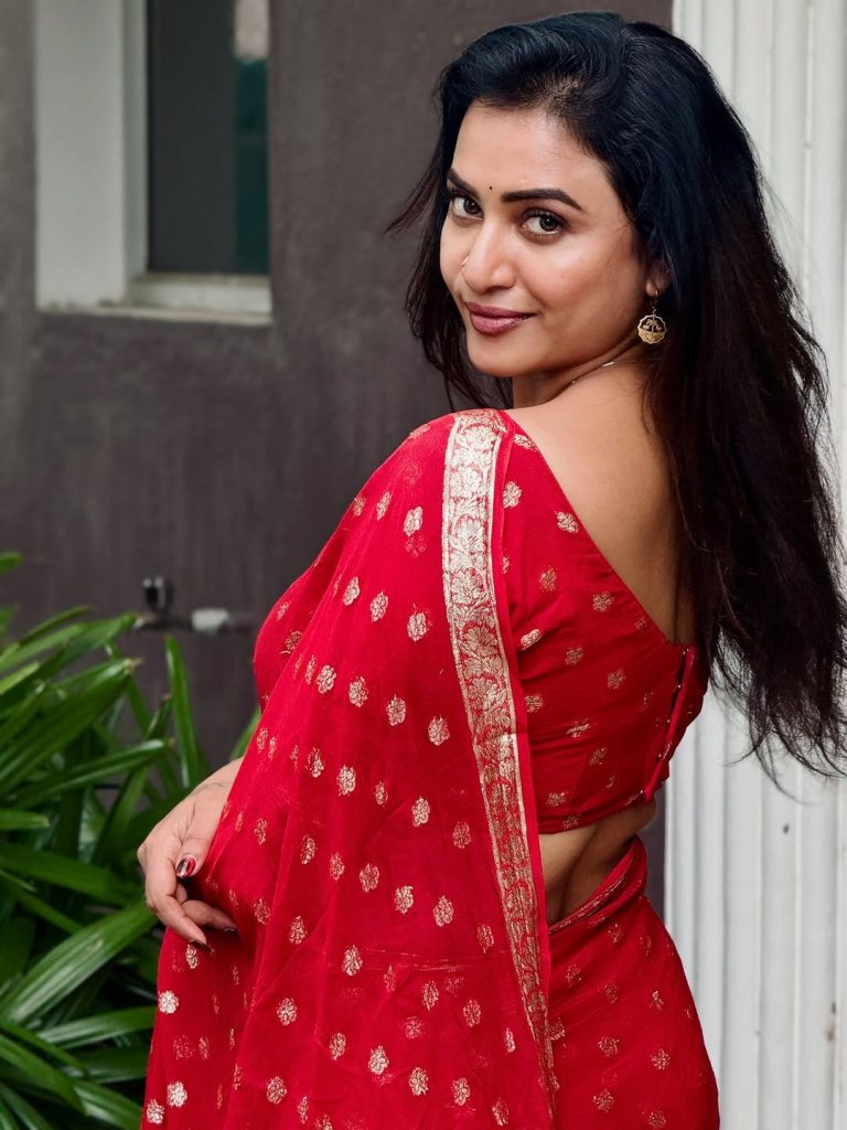 Traditional red saree with gold zari border showcases Janani Ashok Kumar's luxury fashion