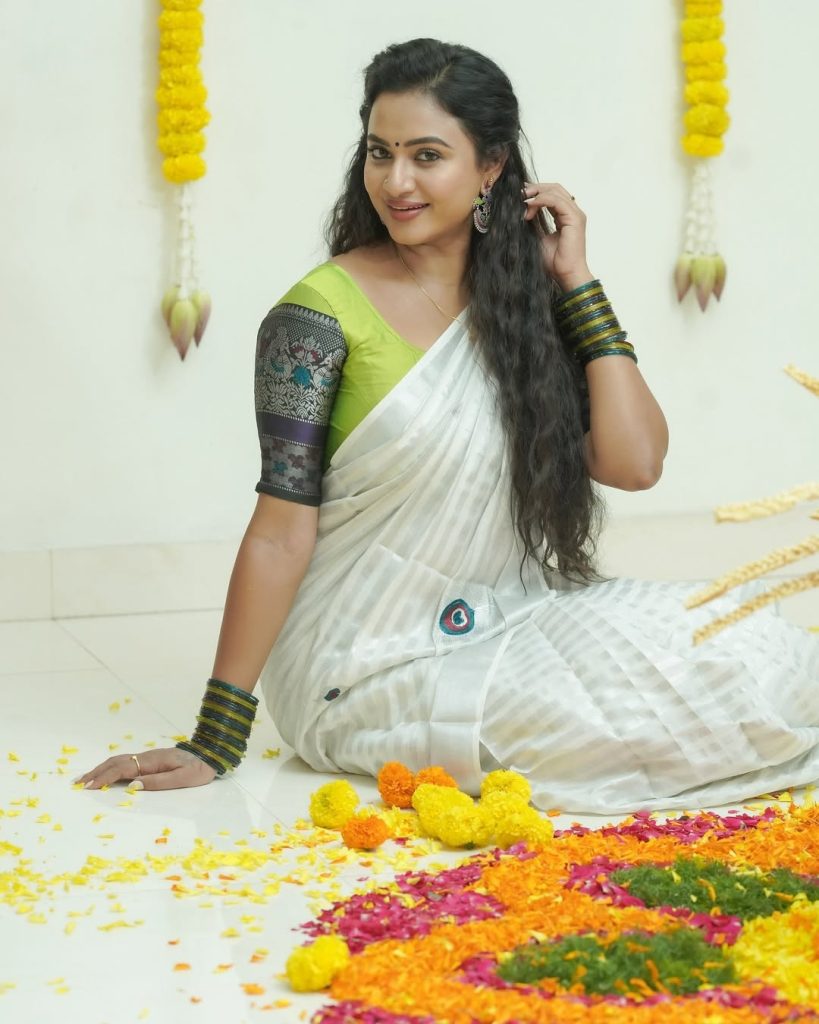 Elegant white saree coordination showcases Janani Ashok Kumar's embroidered green blouse