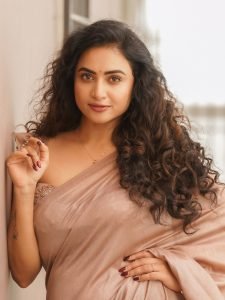 Soft brown draping creates elegant silhouette for Janani Ashok Kumar's styling