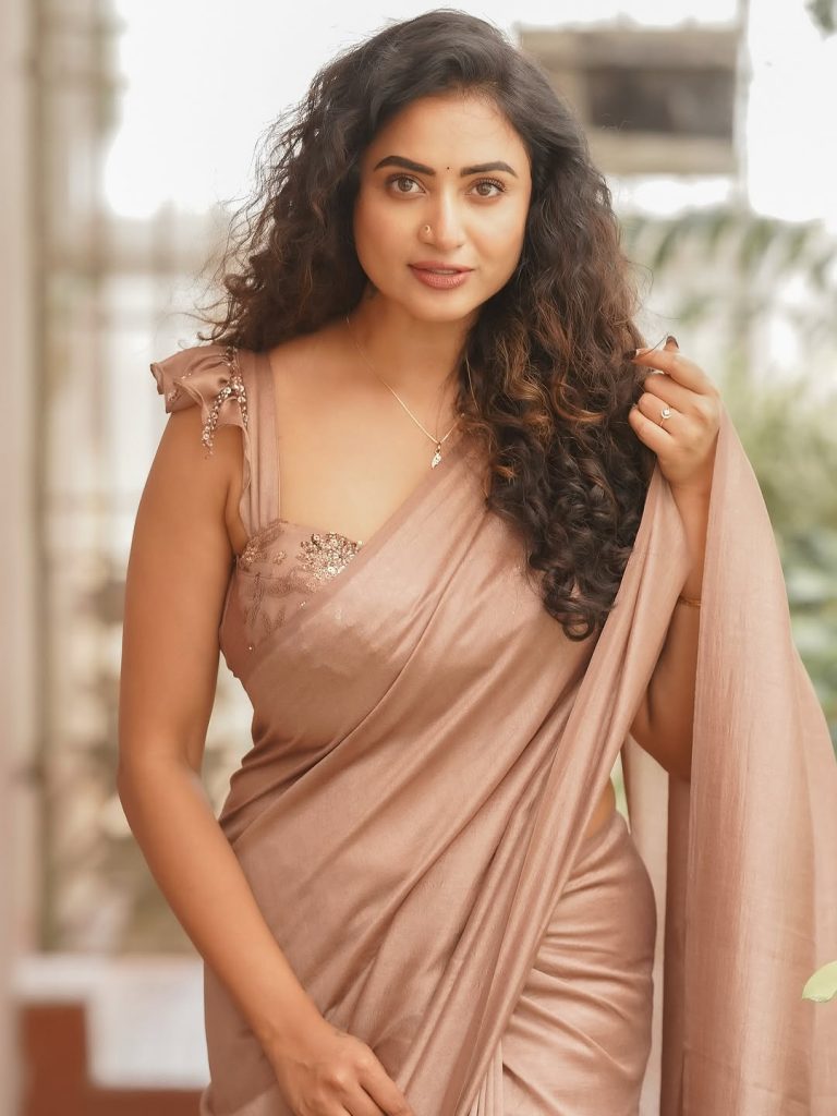 Soft brown draping creates elegant silhouette for Janani Ashok Kumar's styling