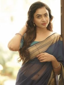 Janani Ashok Kumar embodies sophistication in saree with beautiful curled hair
