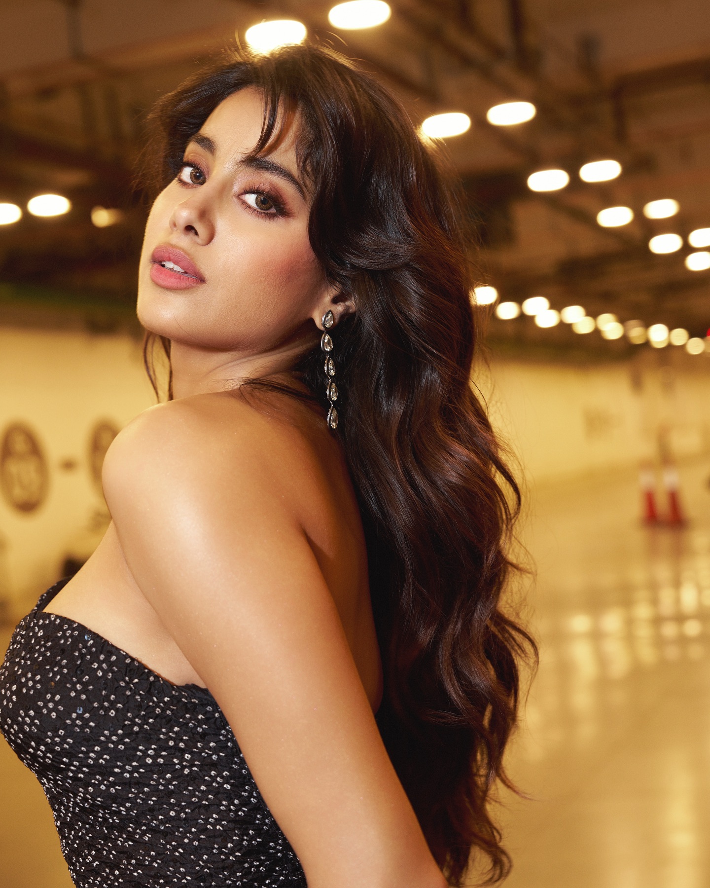 Janhvi's confident pose highlights sleek black dress silhouette