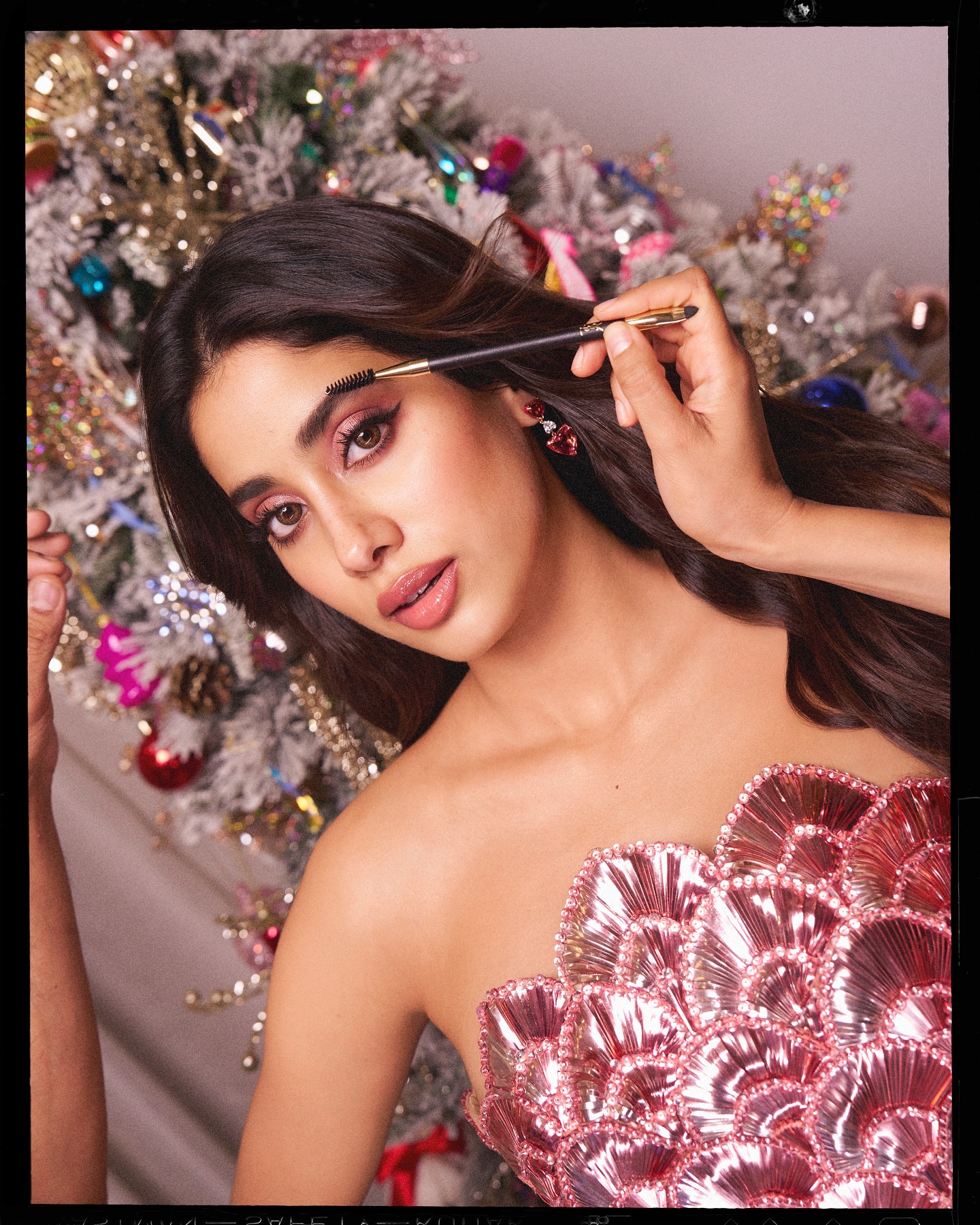 Glittery pink fabric catches studio lights perfectly on Janhvi's figure