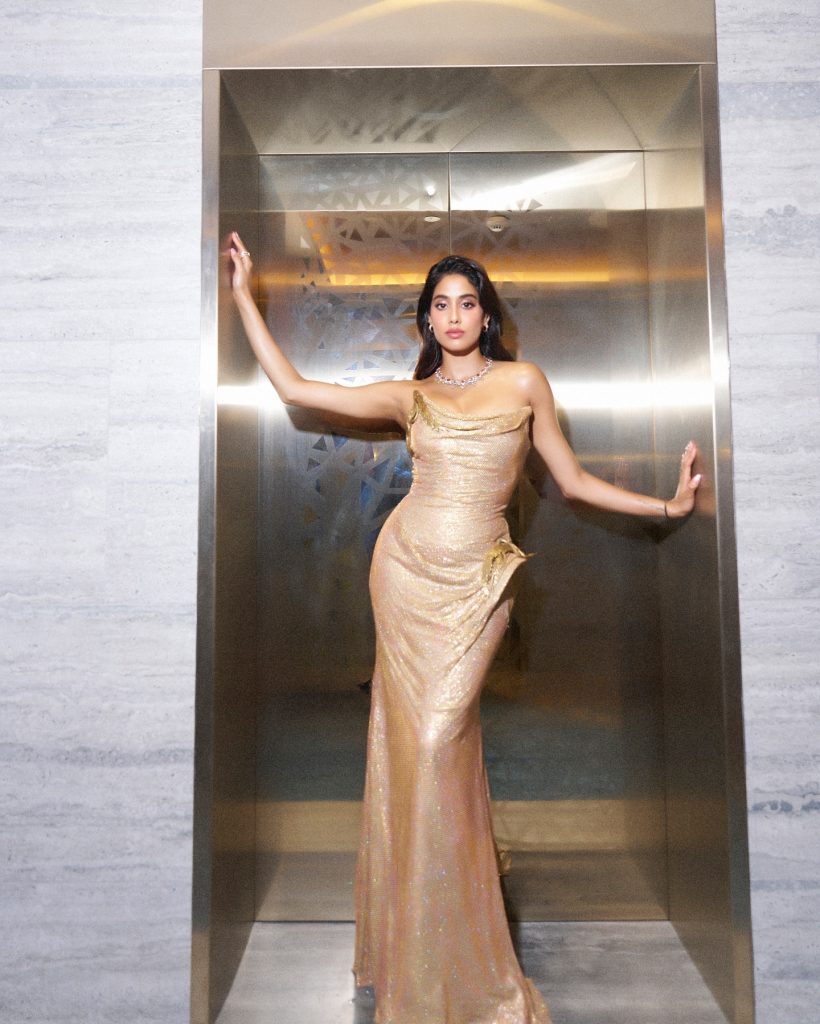 Metallic golden fabric catches light beautifully in Janhvi's portrait