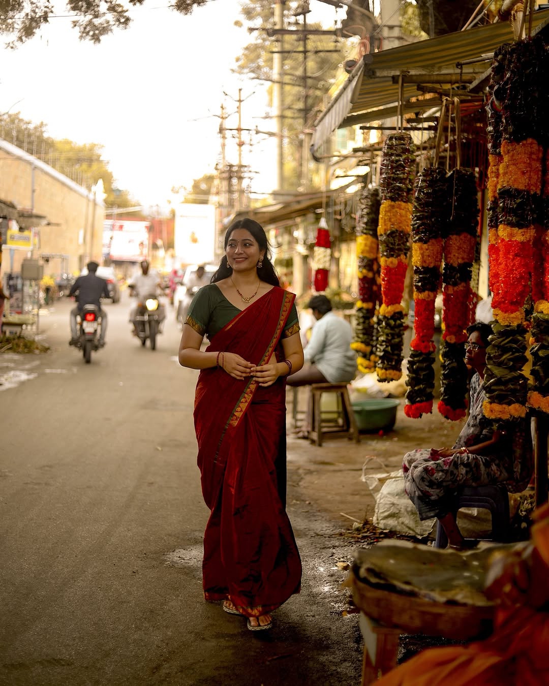 Warm maroon tones create cozy, inviting traditional styling atmosphere for Kanduri Sudha