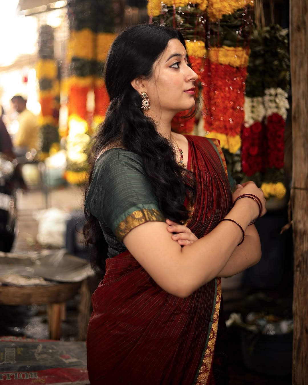 Cute expressions enhanced by Kanduri Sudha's rich maroon saree's earthy elegance