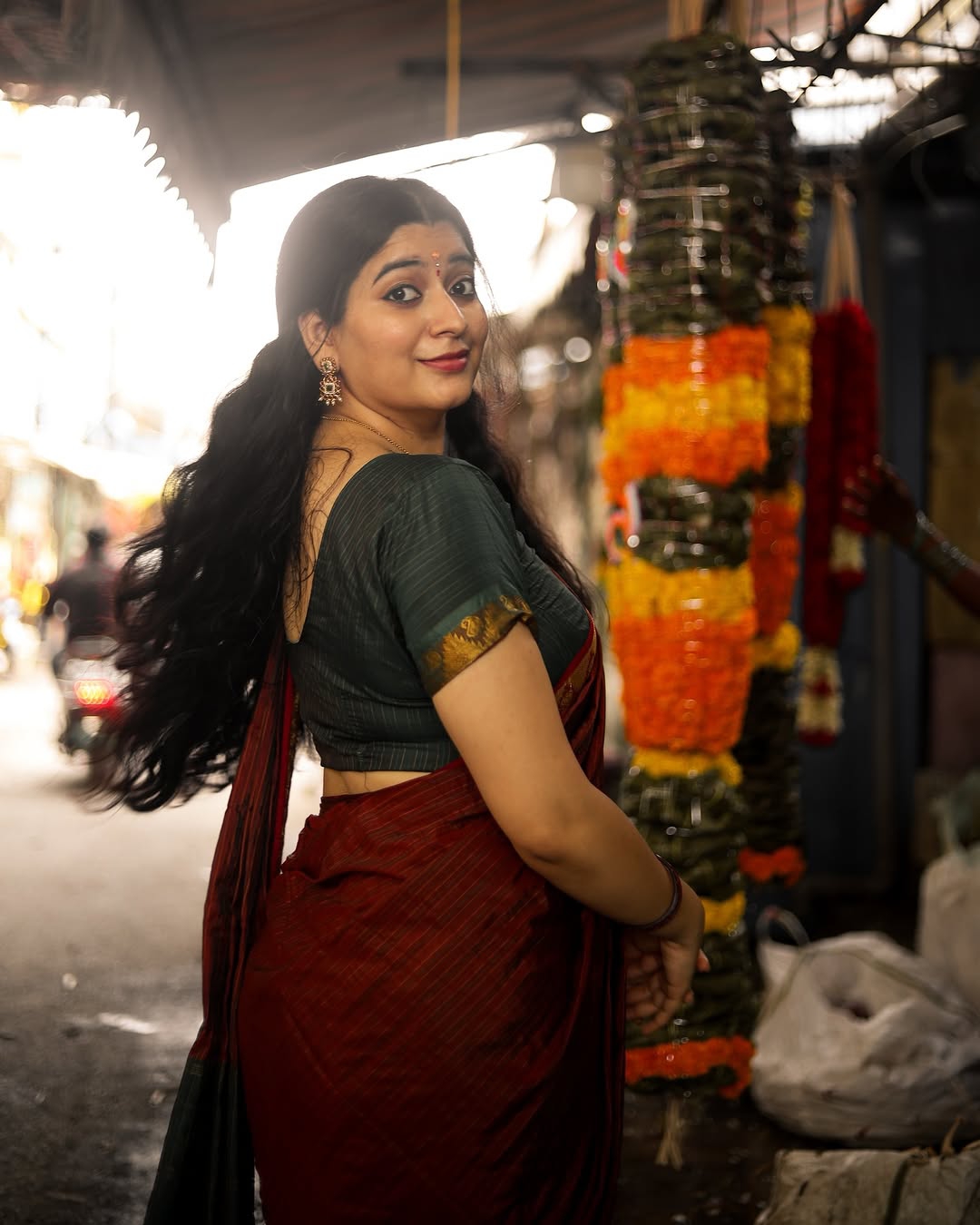 Adorable styling in deep maroon creates heartwarming portrait effect for Kanduri Sudha