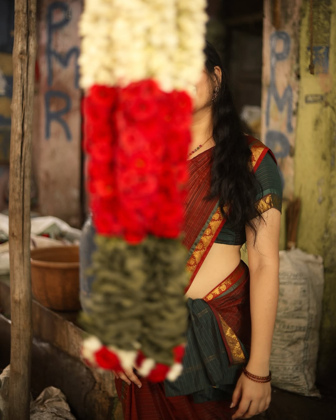 Warm maroon tones create cozy, inviting traditional styling atmosphere for Kanduri Sudha