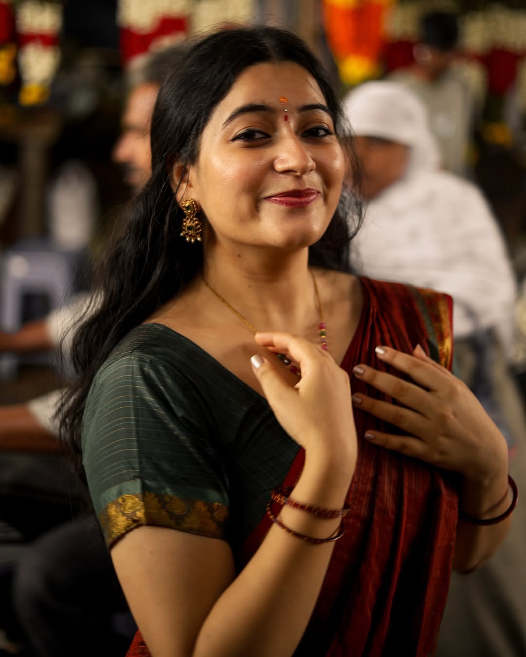 Warm maroon tones create cozy, inviting traditional styling atmosphere for Kanduri Sudha