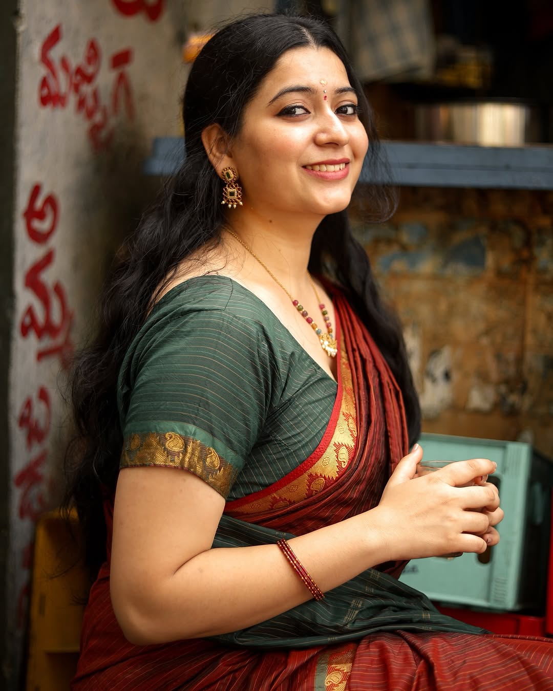 Warm maroon tones create cozy, inviting traditional styling atmosphere for Kanduri Sudha