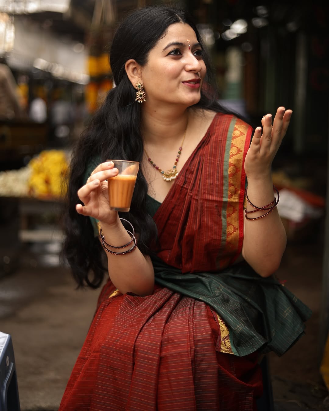 Cute expressions enhanced by Kanduri Sudha's rich maroon saree's earthy elegance