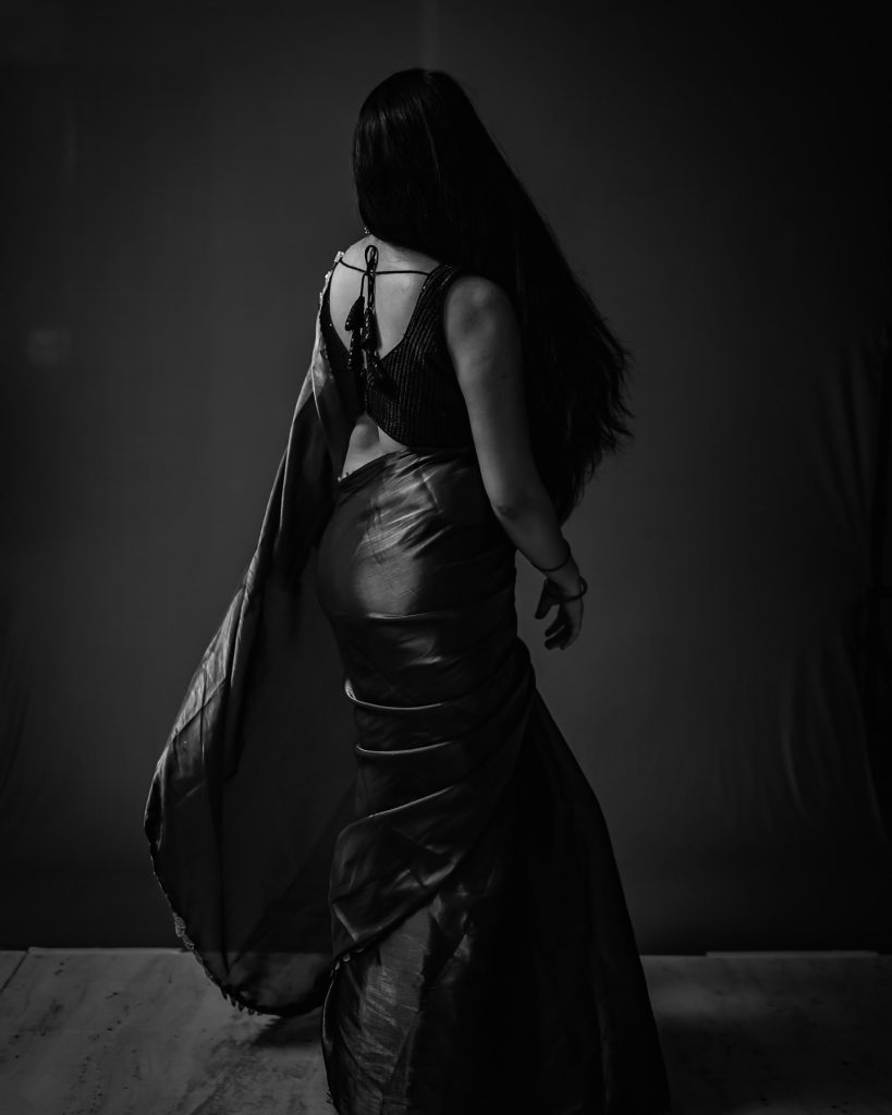 Rich chocolate brown saree drapes elegantly on Kanduri Sudha's figure