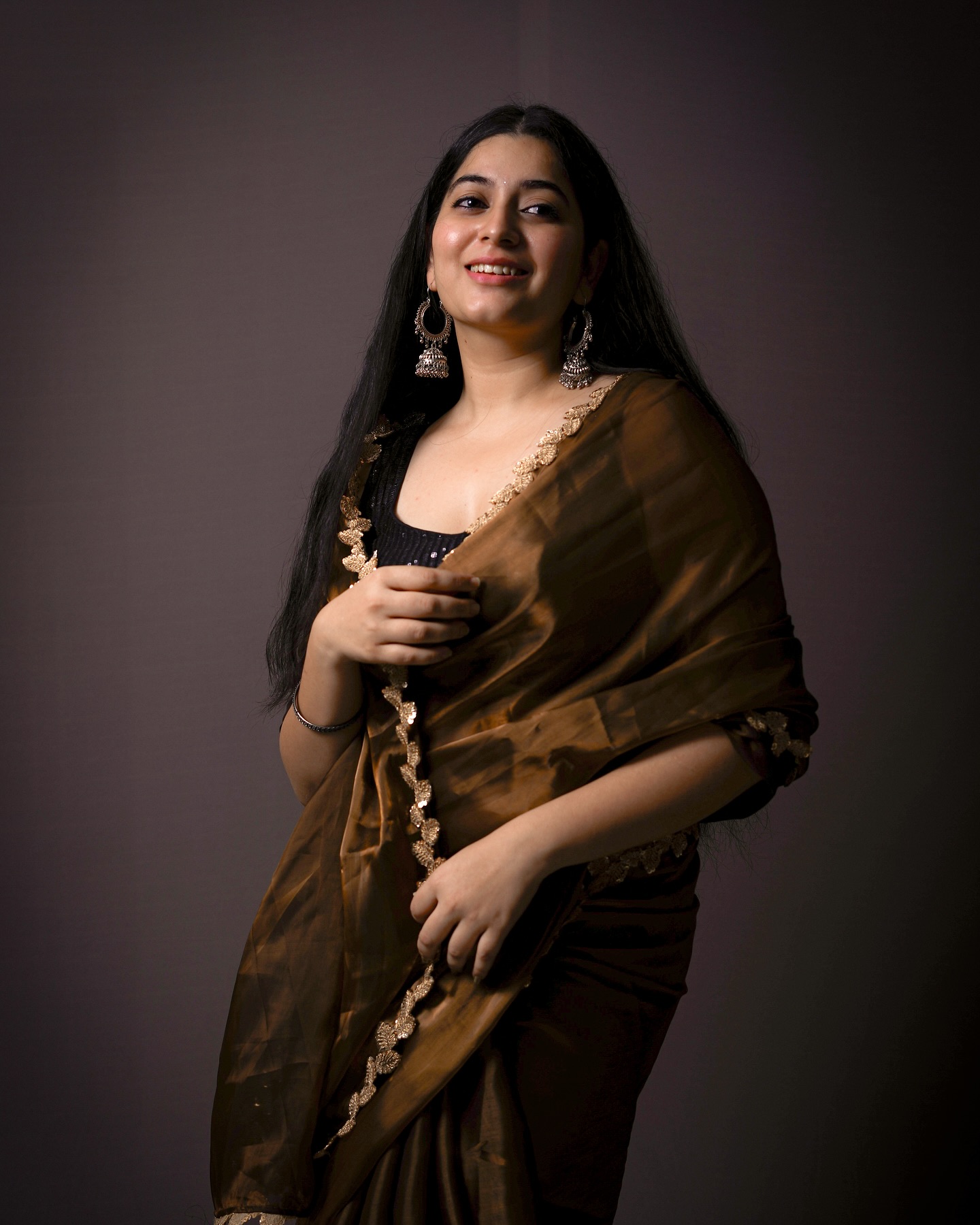 Warm brown tones complement Kanduri Sudha's natural complexion perfectly