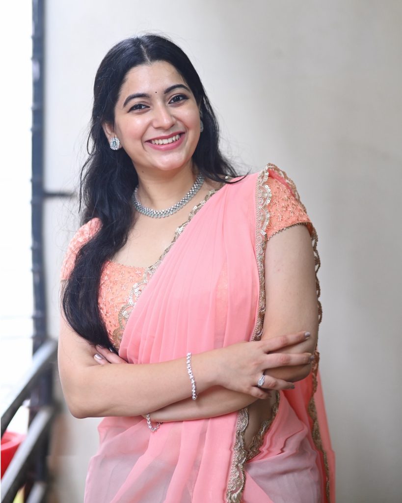 Feminine pink drape enhances Kanduri Sudha's natural beauty and charm