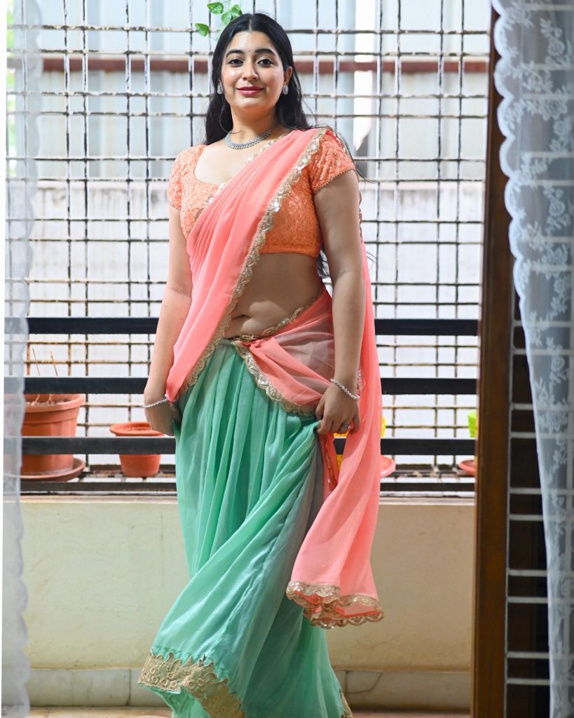 Vibrant pink saree creates stunning contrast against studio backdrop with Kanduri Sudha