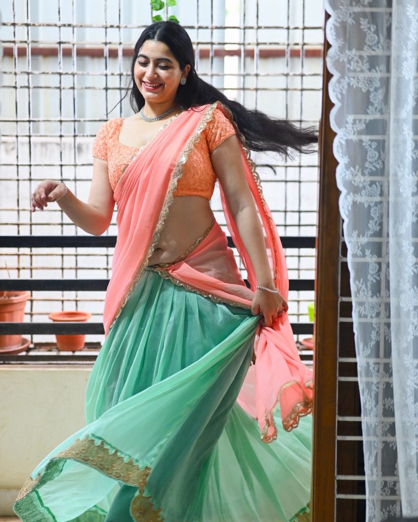 Vibrant pink saree creates stunning contrast against studio backdrop with Kanduri Sudha