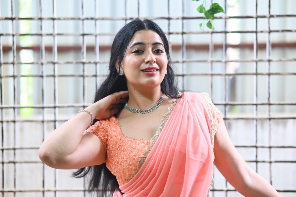 Feminine pink drape enhances Kanduri Sudha's natural beauty and charm