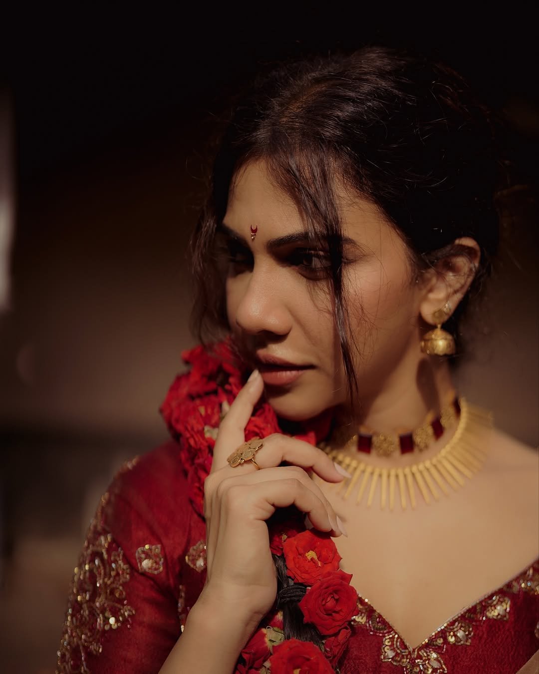 Madonna Sebastian in traditional red bridal attire with statement gold jewelry (10)