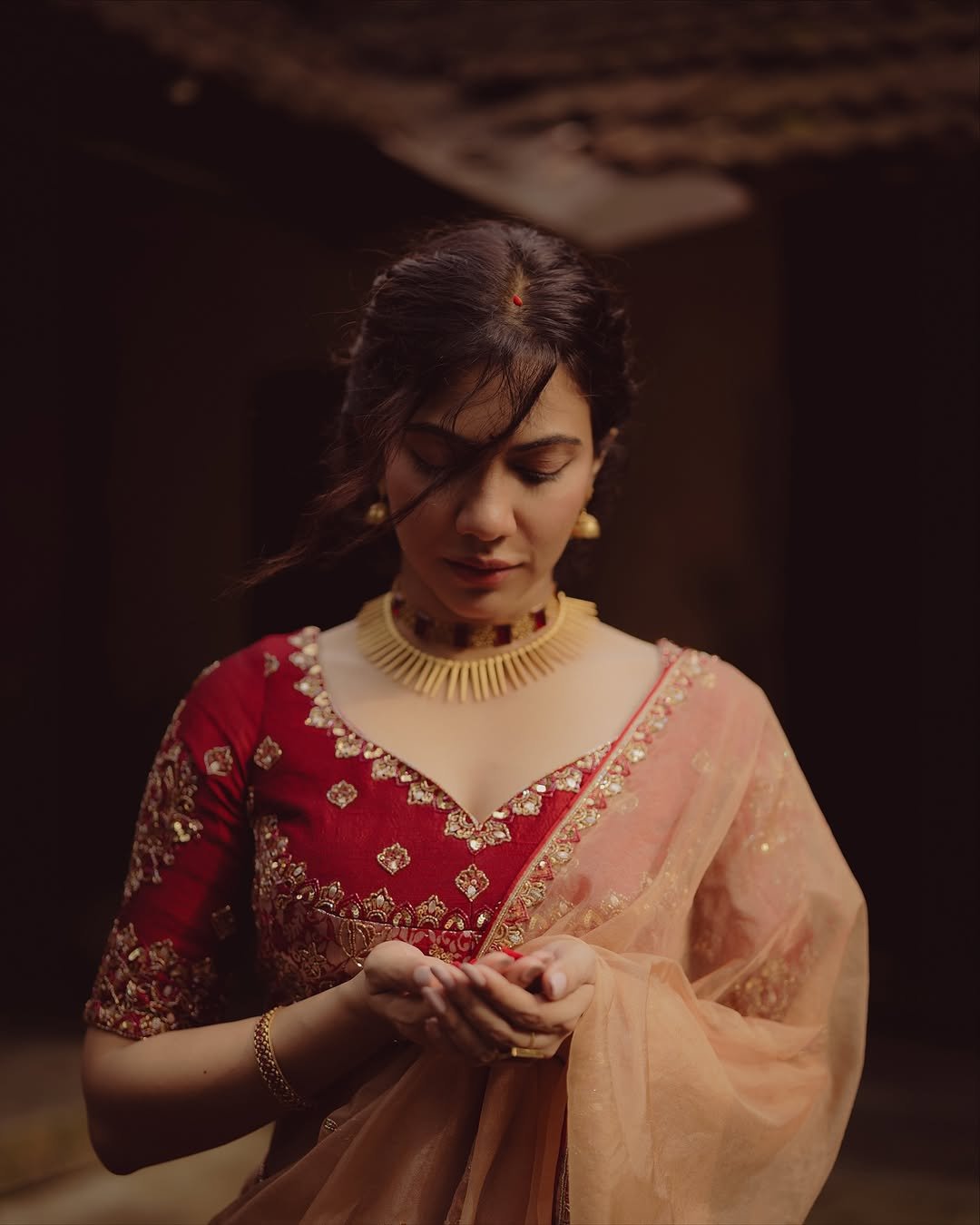 Madonna Sebastian in traditional red bridal attire with statement gold jewelry (5)