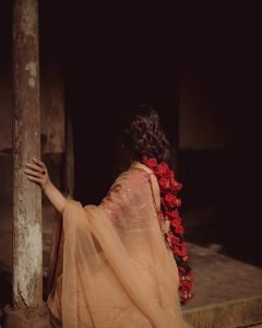 Stunning gold jewelry complements Madonna Sebastian's red bridal traditional styling