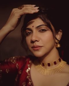 Stunning gold jewelry complements Madonna Sebastian's red bridal traditional styling