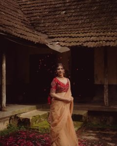 Stunning gold jewelry complements Madonna Sebastian's red bridal traditional styling