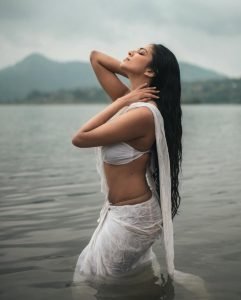 Water photography showcases Malavika's wet white saree's flowing elegance