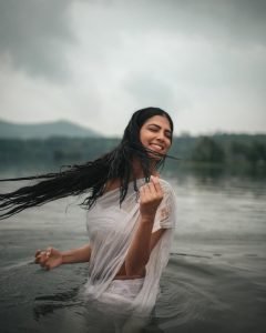 Malavika embodies natural beauty in wet white saree with flowing water backdrop