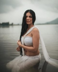 Malavika embodies natural beauty in wet white saree with flowing water backdrop
