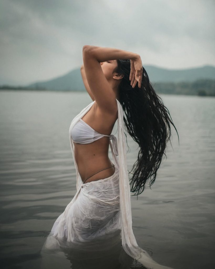 Water photography showcases Malavika's wet white saree's flowing elegance