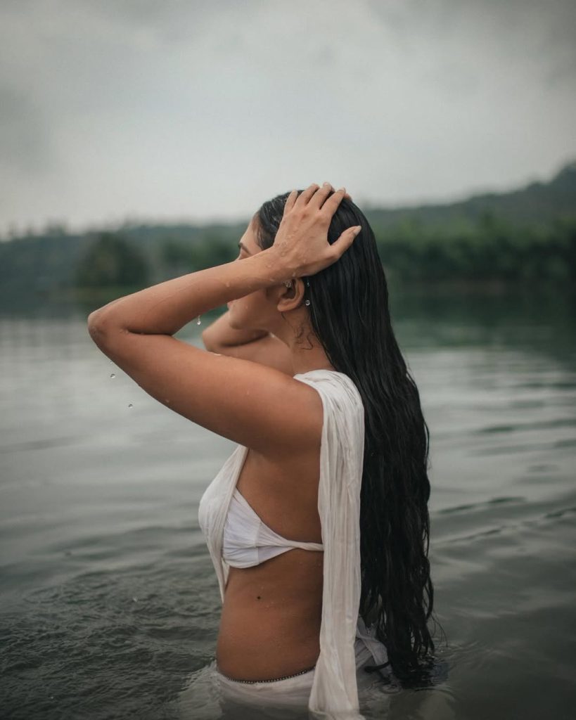 Water photography showcases Malavika's wet white saree's flowing elegance