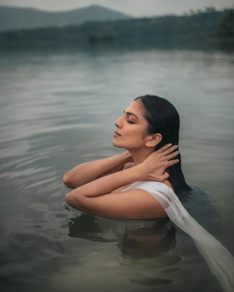 Riverside photoshoot captures Malavika's ethereal wet saree presentation