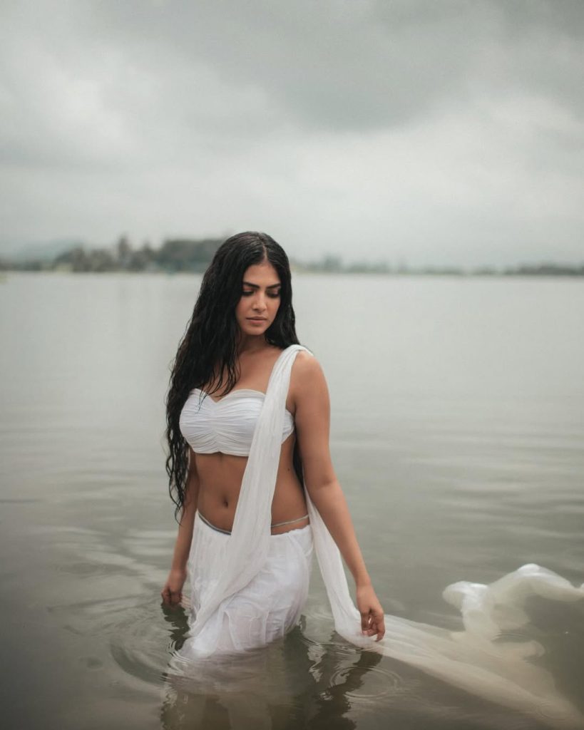 Riverside photoshoot captures Malavika's ethereal wet saree presentation