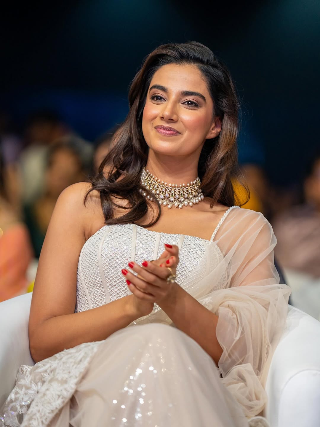 Elegant white dress creates sophisticated styling for Meenakshi Chaudhary's portrait