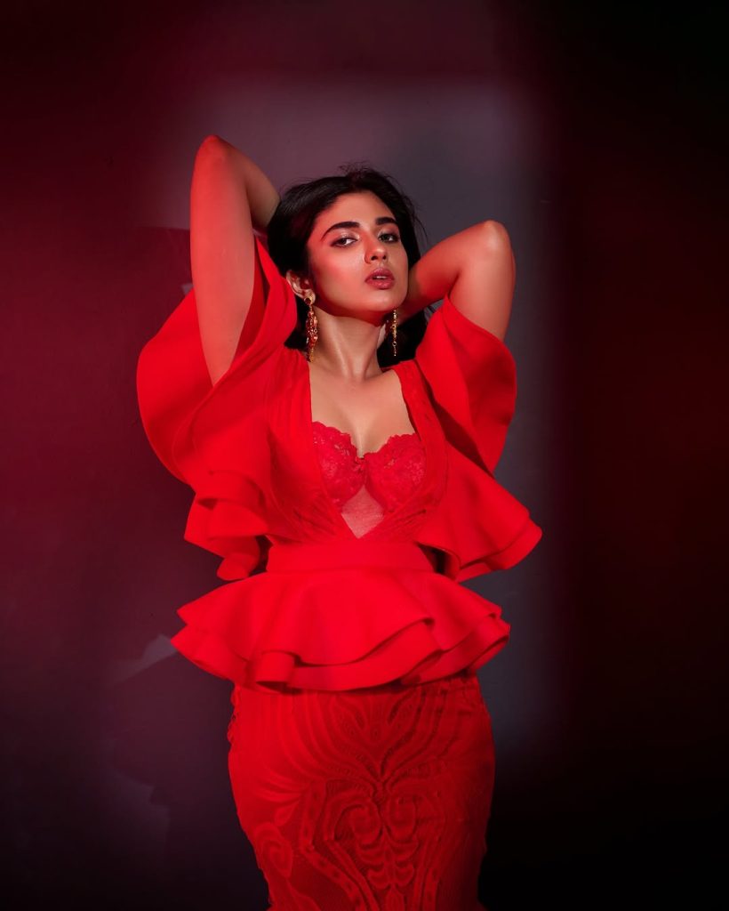 Striking crimson color creates dramatic impact against Pragya Nagra's neutral backdrop