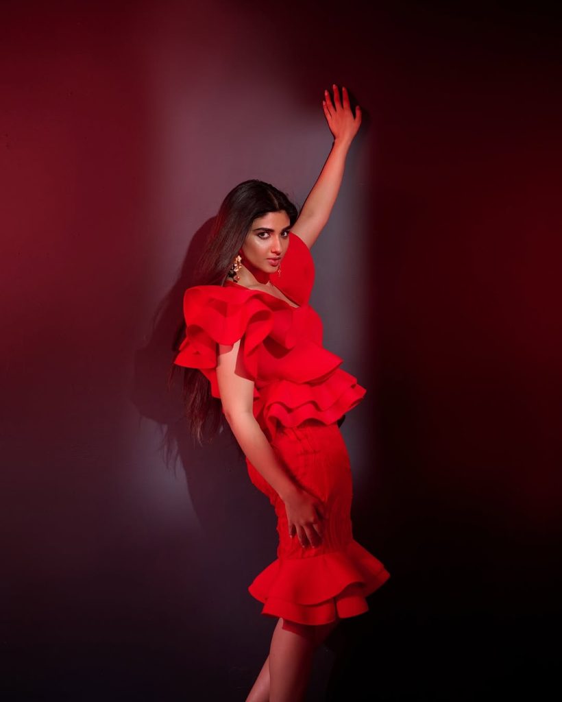 Striking crimson color creates dramatic impact against Pragya Nagra's neutral backdrop