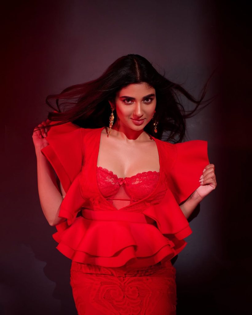 Striking crimson color creates dramatic impact against Pragya Nagra's neutral backdrop
