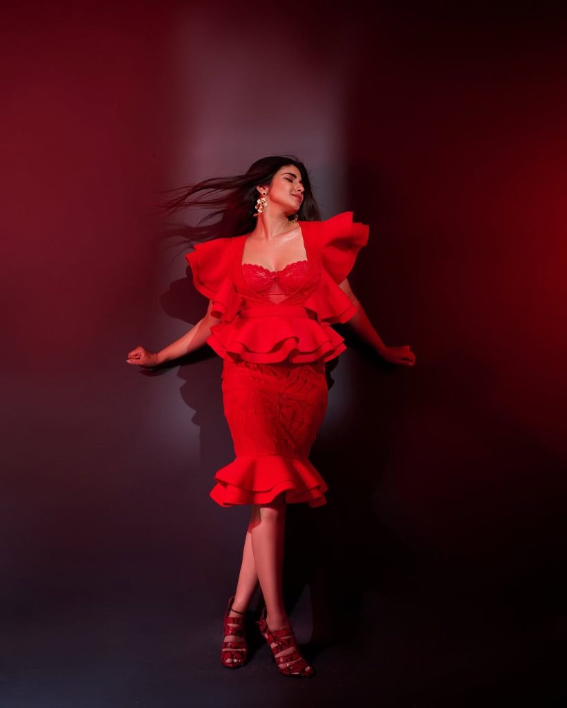 Striking crimson color creates dramatic impact against Pragya Nagra's neutral backdrop